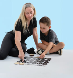 Young boy and teacher enjoying a fun, hands-on learning activity